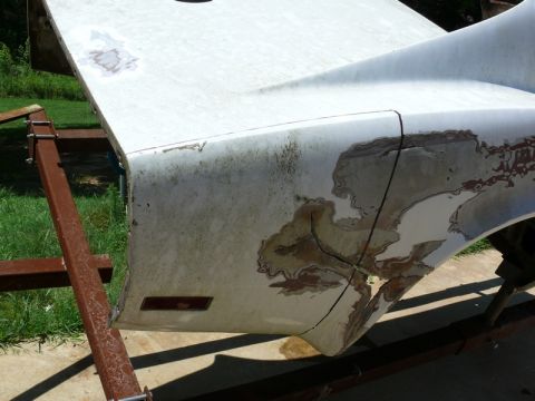 1976 Chevrolet Corvette - Car body panel undergoing restoration, showing significant wear and damage.