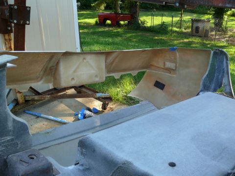 1976 Chevrolet Corvette - A car bumper part is shown on a stand outdoors, with a red truck visible in the background.