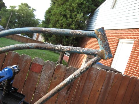 1994 Ford Bronco - Close-up of a rusted metal frame, possibly from a bicycle or motorcycle, with a power tool visible.