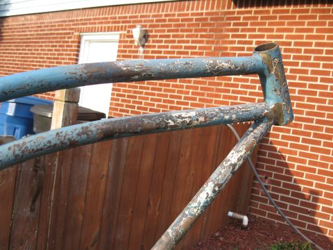 1994 Ford Bronco - A close-up of a weathered blue bicycle frame shows signs of age and disuse.
