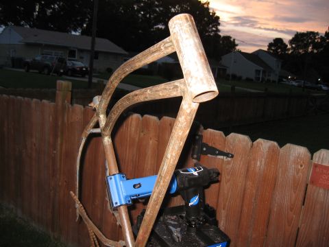 1994 Ford Bronco - A bicycle frame and tools are staged in front of a wooden fence at dusk.