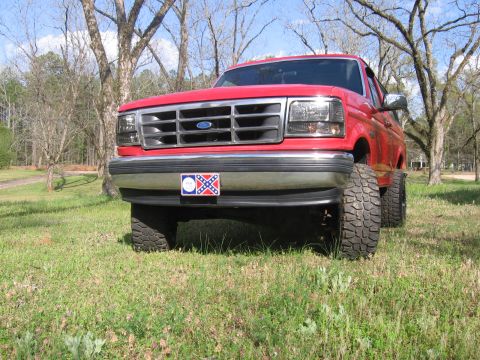 1992 Ford Bronco - This 1992 Ford Bronco is shown from the front, a prominent grille and a decorative license plate.