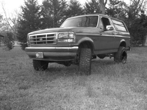 1992 Ford Bronco - This 1992 Ford Bronco is shown from a three-quarter front view, parked outdoors on a grassy lawn.