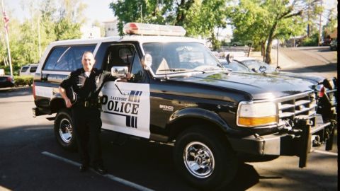 1992 Ford Bronco - A police officer stands next to a Lakeport Police Ford Bronco SUV.