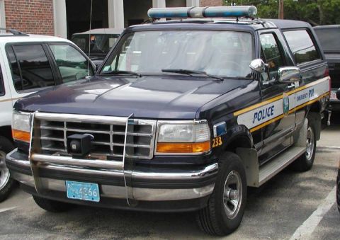 1992 Ford Bronco - This police SUV, identified as a 1992 Ford Bronco, is equipped with emergency lights and markings.