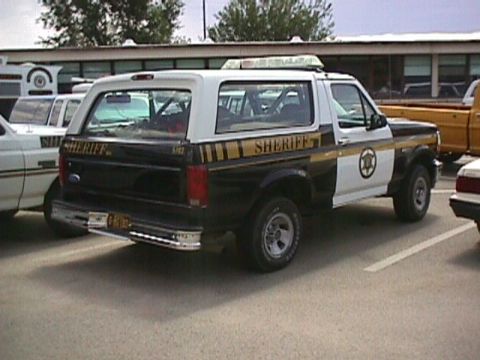 1992 Ford Bronco - This 1992 Ford Bronco is marked as a sheriff's vehicle, a black and white paint scheme and emergency lights.