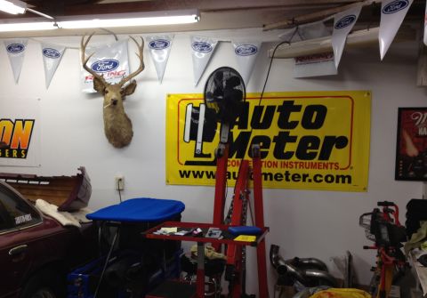 1992 Ford Crown Victoria - A garage scene with automotive memorabilia and a mounted deer head.
