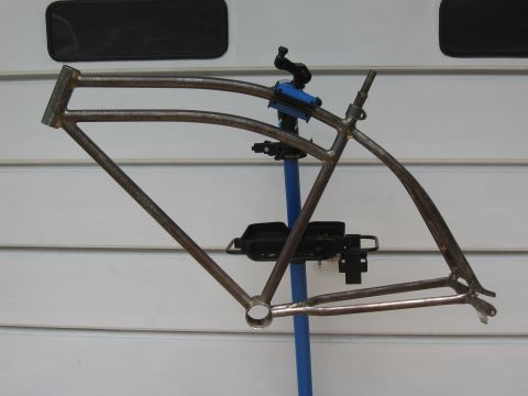1994 Ford Bronco - A bare bicycle frame is mounted on a repair stand, ready for customization.