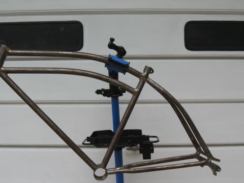 1994 Ford Bronco - A bare bicycle frame is mounted on a repair stand, ready for customization.