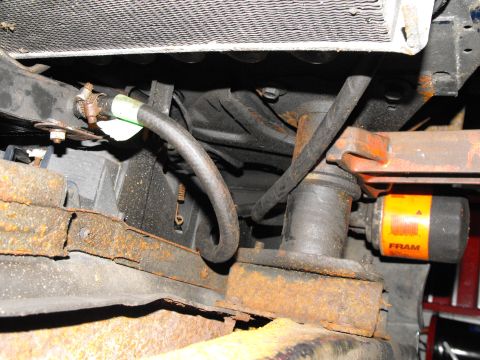 1986 Chrysler Fifth Avenue - There's the hose coming from the rad cooling loop, sneaking along under the rad, through the core support (no drilling required, plenty of…