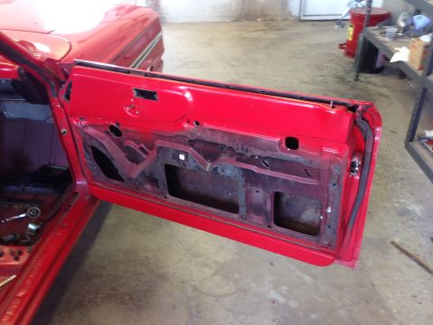 1964 Ford Fairlane - Interior view of a 1964 Ford Fairlane door, stripped down for work.