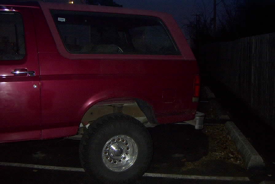 1994 Ford Bronco side view, parked at night