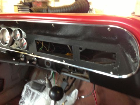 1964 Ford Fairlane - Interior view of a car dashboard with gauges and wiring, possibly undergoing restoration.