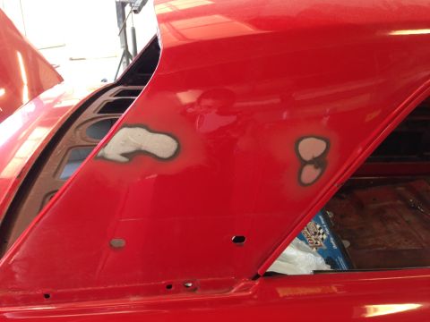 1964 Ford Fairlane - Car body panel shows primer spots indicating repair work, with the hood open.