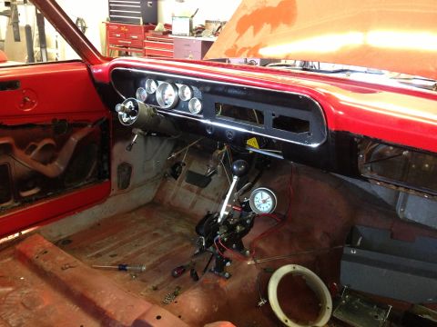 1964 Ford Fairlane - The interior of a classic car is shown with the dashboard and floor exposed, indicating ongoing restoration work.