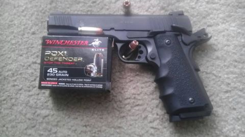 2000 Mercury Grand Marquis - A black semi-automatic pistol is shown next to a box of Winchester PDX1 Defender ammunition.