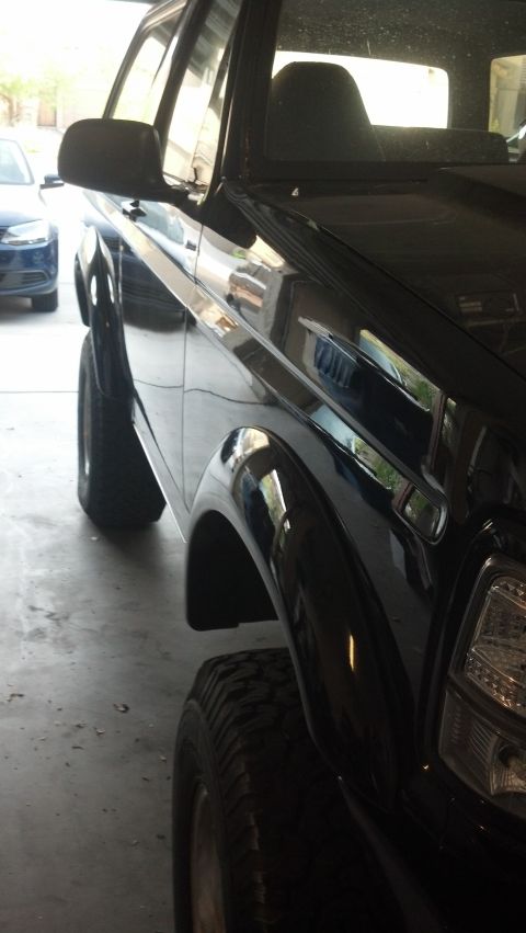 1995 Ford Bronco - This black 1995 Ford Bronco is captured from a 3/4 front angle, its build.