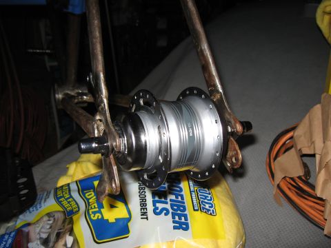 1994 Ford Bronco - A close-up view of a silver bicycle rear hub, identified by the text "SG-7C18", is mounted to the bicycle frame.
