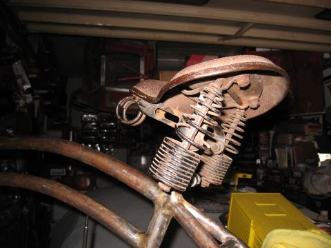 1994 Ford Bronco - Close-up of a vintage bicycle seat showing its spring mechanism and weathered condition.