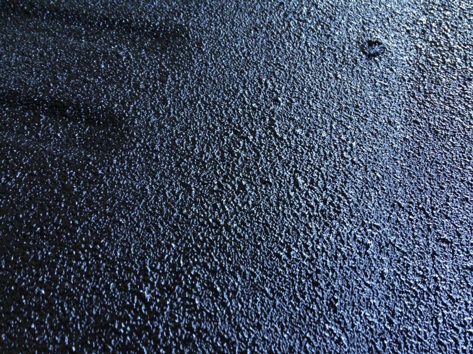 Dark textured surface with watermarks