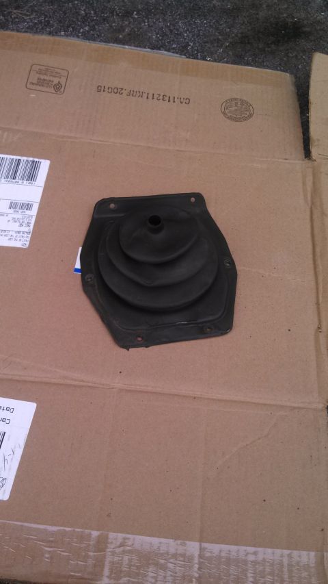 1979 Ford Bronco - A black rubber shift boot is shown resting on a piece of cardboard with shipping labels.