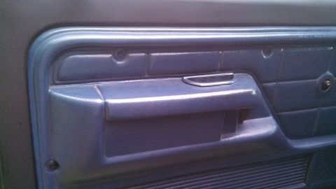 1979 Ford Bronco - Close-up of the blue interior door panel on a 1979 Ford Bronco.