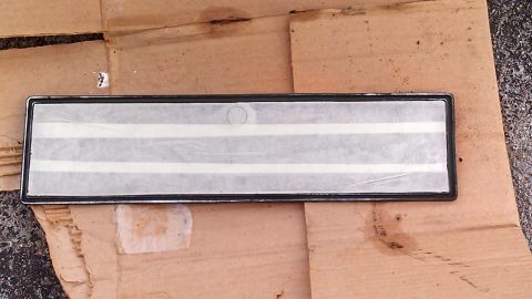 1979 Ford Bronco - A close-up view of a vehicle's exterior trim piece, possibly a nameplate or emblem backing.