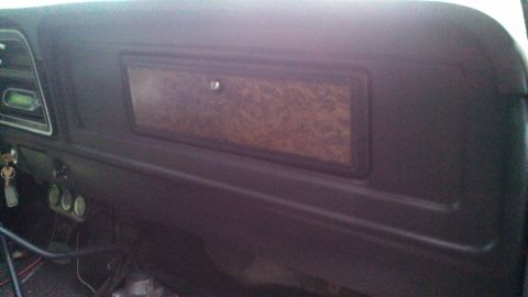 1979 Ford Bronco - Interior view of a 1979 Ford Bronco dashboard, showing woodgrain trim and gauges.