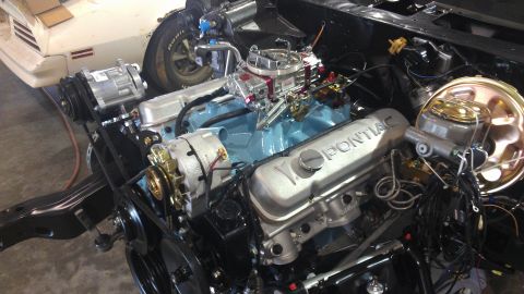 1972 Pontiac Trans Am - Close-up of a 1972 Pontiac Trans Am engine assembly, showing the V8 engine block, intake, and carburetor.
