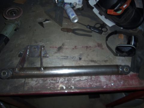 1968 Ford Bronco - Custom metal fabrication part, possibly for a vehicle, on a workbench with tools.