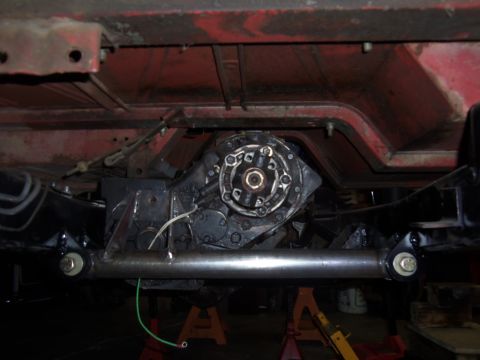 1968 Ford Bronco - The transfer case and crossmember assembly are shown from below, supported by jack stands.