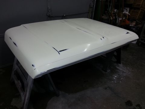 1967 Ford F-100 - A vehicle hood is prepped for paint, with visible sanding marks and primer.