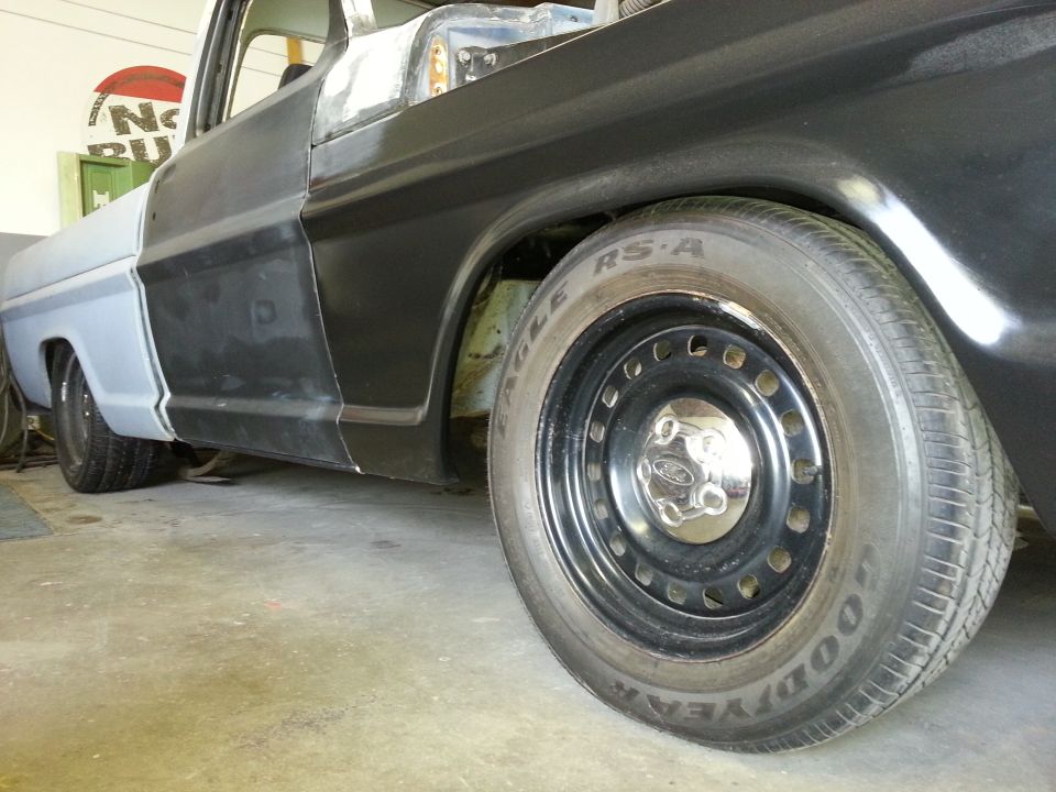 1967 Ford F-100 truck, primer gray rear fender, black door, steel wheels, undergoing bodywork