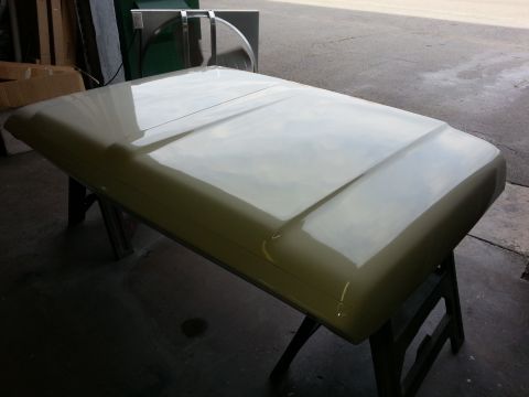 1967 Ford F-100 - A truck hood is shown resting on sawhorses, likely awaiting further work or installation.