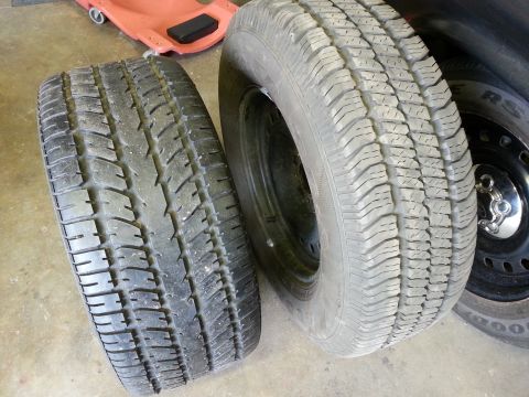 1967 Ford F-100 - Two tires are shown, one mounted on a black steel wheel.
