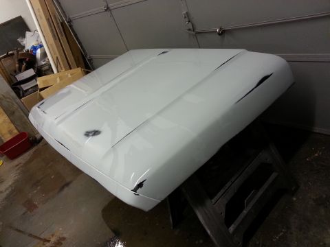 1967 Ford F-100 - White 1967 Ford F-100 hood shows damage on the front corners and along the center crease.