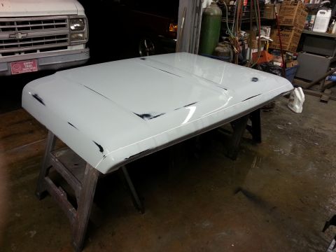 1967 Ford F-100 - Car hood undergoing preparation in a workshop environment.