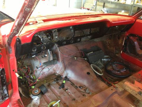 1964 Ford Fairlane - Interior of a car undergoing restoration, showing exposed wiring and a bare floor.