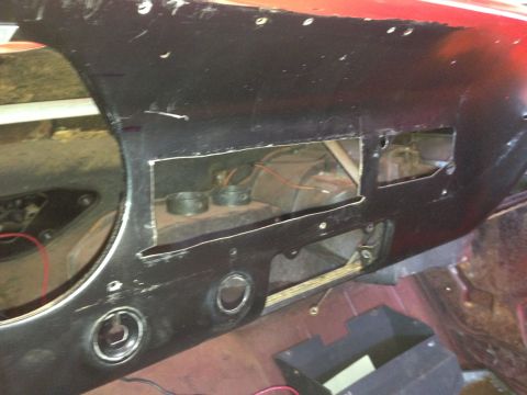 1964 Ford Fairlane - The dashboard of a car is shown with openings for components and exposed wiring and internal parts.