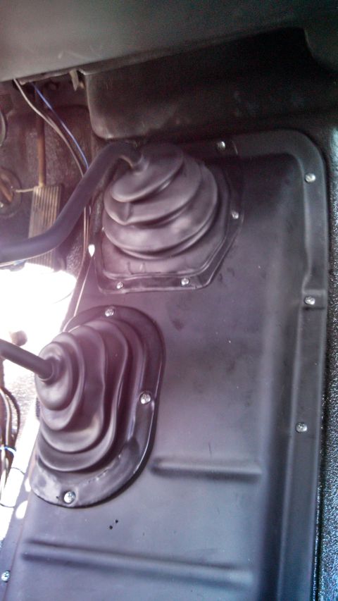 1979 Ford Bronco - Close-up of the floor console area showing two shifter boots, likely for manual transmission and 4WD.