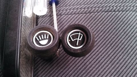 1979 Ford Bronco - Close-up of interior dashboard knobs, one depicting a light symbol and the other a windshield wiper symbol.
