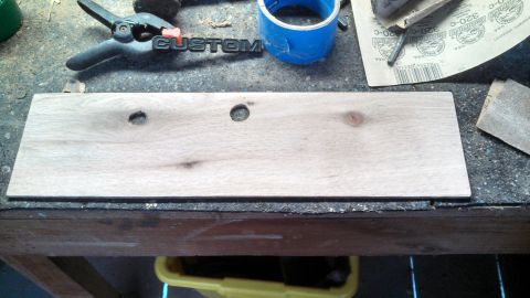 1979 Ford Bronco - Workbench setup with a wooden plank, clamp, and sanding supplies.