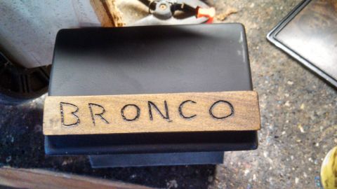 1979 Ford Bronco - Hand-burned wooden nameplate spelling out 'BRONCO' is shown.