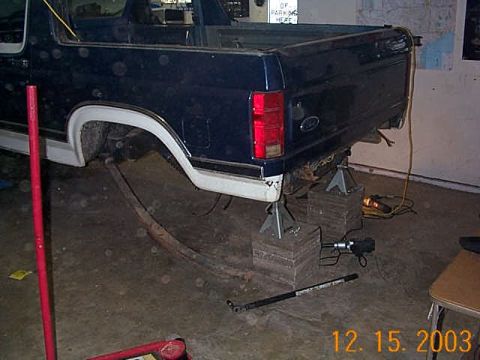 1986 Ford Bronco - Rear axle removed from a 1986 Ford Bronco, supported by jack stands.