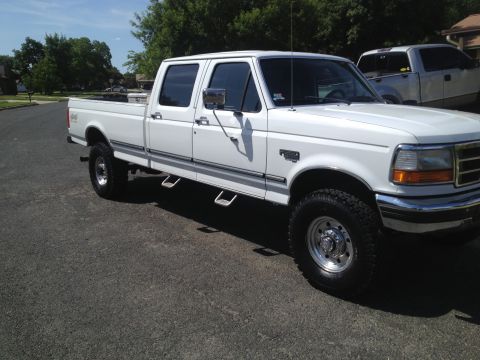 1997 Ford F-350 - This 1997 Ford F-350 crew cab pickup truck is shown from the front three-quarter angle.