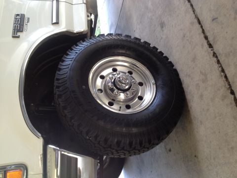 1997 Ford F-350 - Close-up of the front wheel and fender of a 1997 Ford F-350 truck.