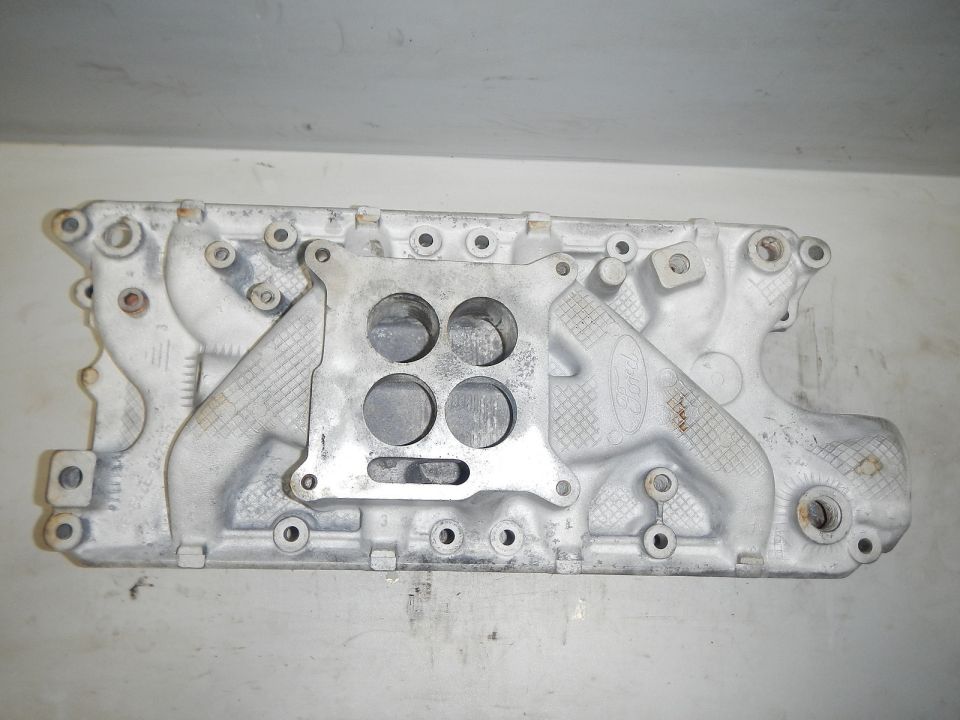 Aluminum Ford intake manifold with four carburetor bolt holes and textured sections