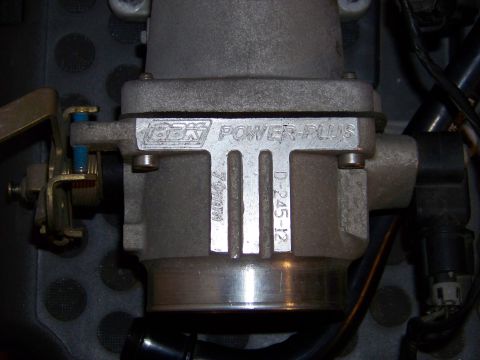 1999 Mercury Grand Marquis - A close-up view of a vehicle's throttle body part, identified by 'GBK Power Plus' and numerical markings.