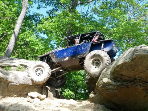1967 Ford Mustang - This custom buggy navigates a challenging rocky terrain with its large tires.