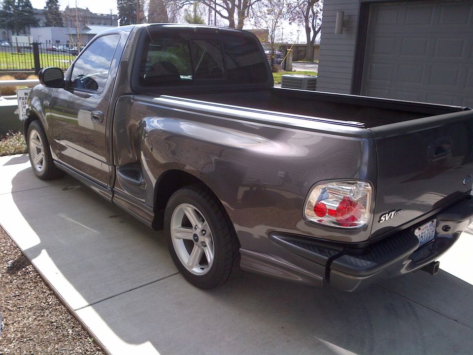 Gray 2003 Ford F-150 SVT Lightning pickup truck parked on a driveway
